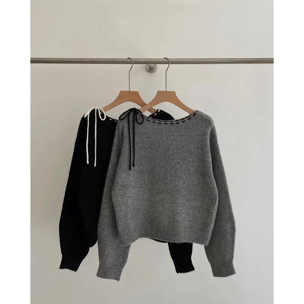 Grey loose-fitting women's pullover jumper on a hanger.