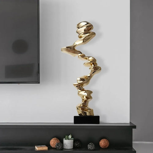 Ran Ran Rose abstract resin sculpture in bright gold, silver, or blue on a neutral background.