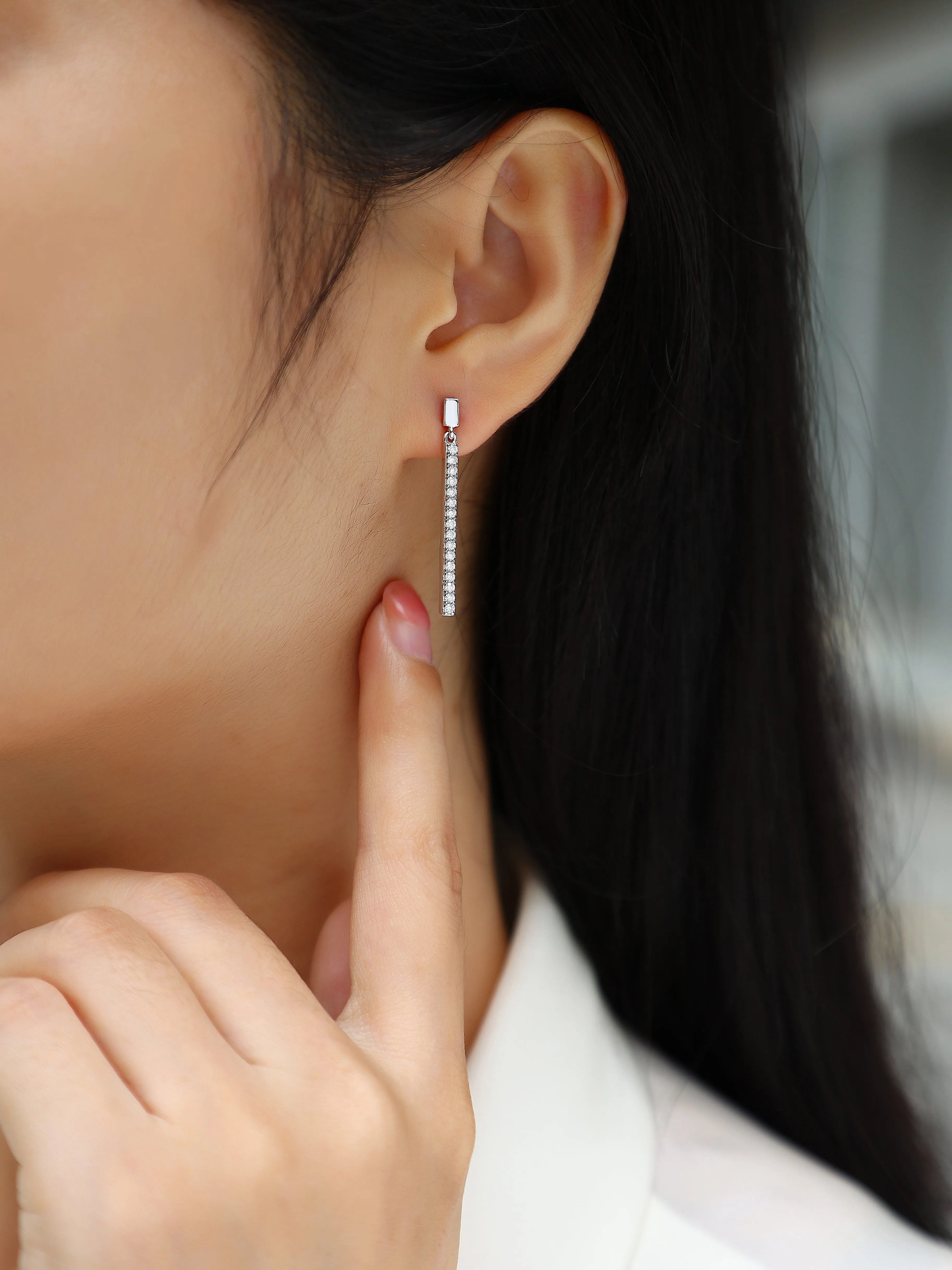 Pair of moissanite stud earrings in S925 silver with platinum plating on white background