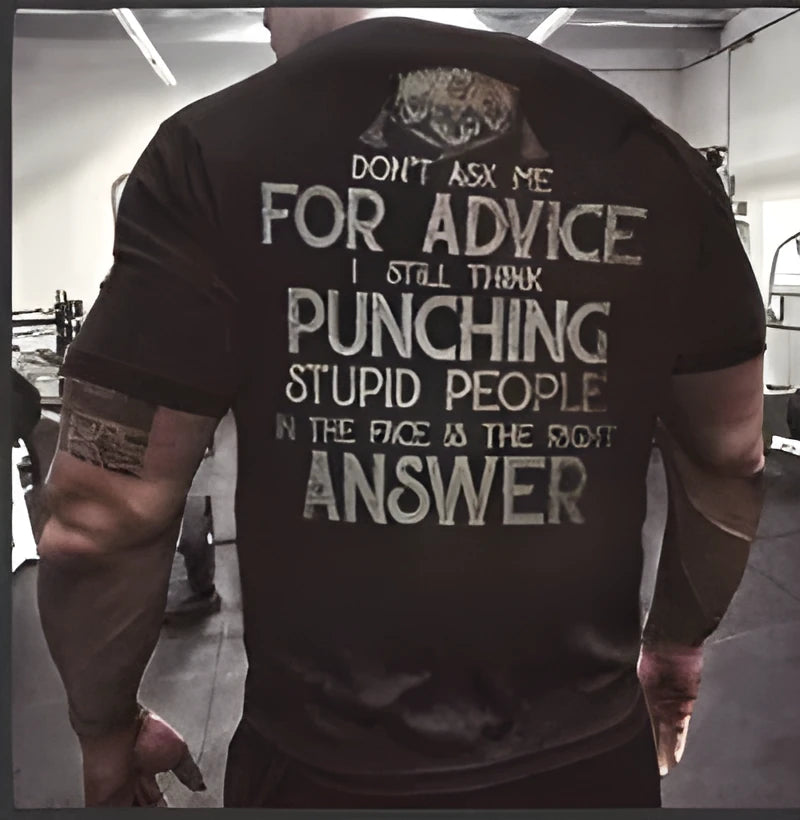 Mens black loose-fit polyester T-shirt with skull and slogan print on front, shown on model