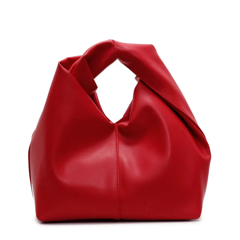 Casual dumpling shaped women's PU handbag in multiple colours showing phone compartment.