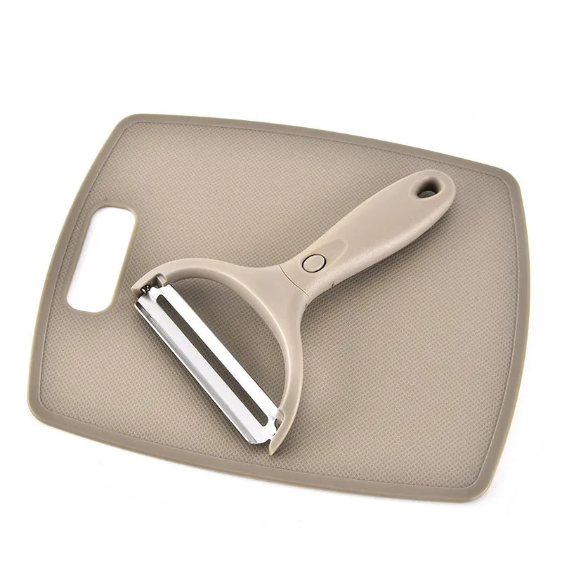 Green eight-piece stainless steel kitchen cutter set with peeler, knife, and integrated chopping board.