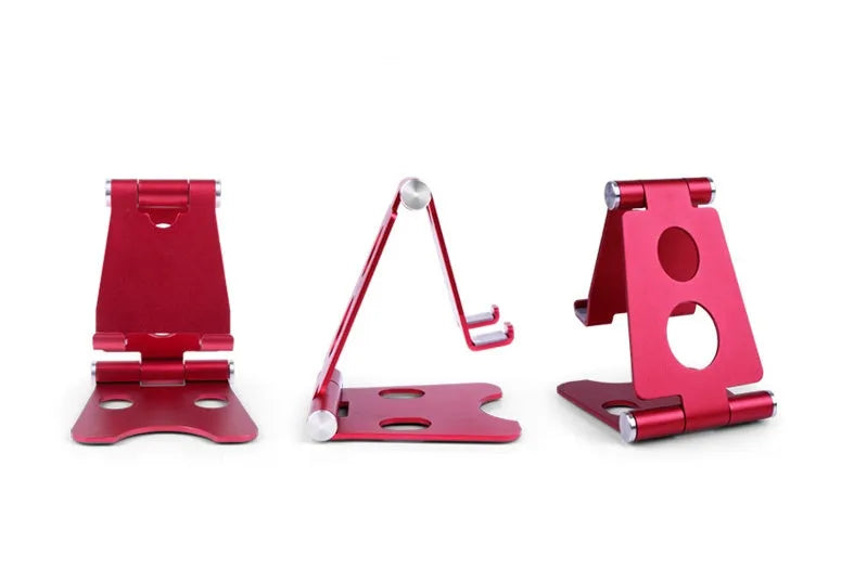 Folding mini mobile phone bracket in black with foldable legs, on a wooden desktop