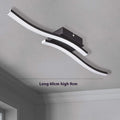 Modern minimalist black flush mount LED ceiling light with aluminium shade, shown on a white ceiling.