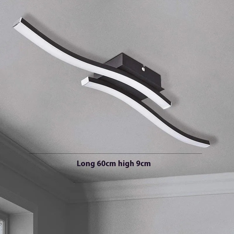 Modern minimalist black flush mount LED ceiling light with aluminium shade, shown on a white ceiling.