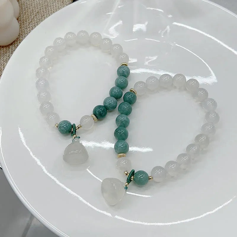 Close-up of a women's retro Chinese style agate bracelet with a carved lotus seedpod design.