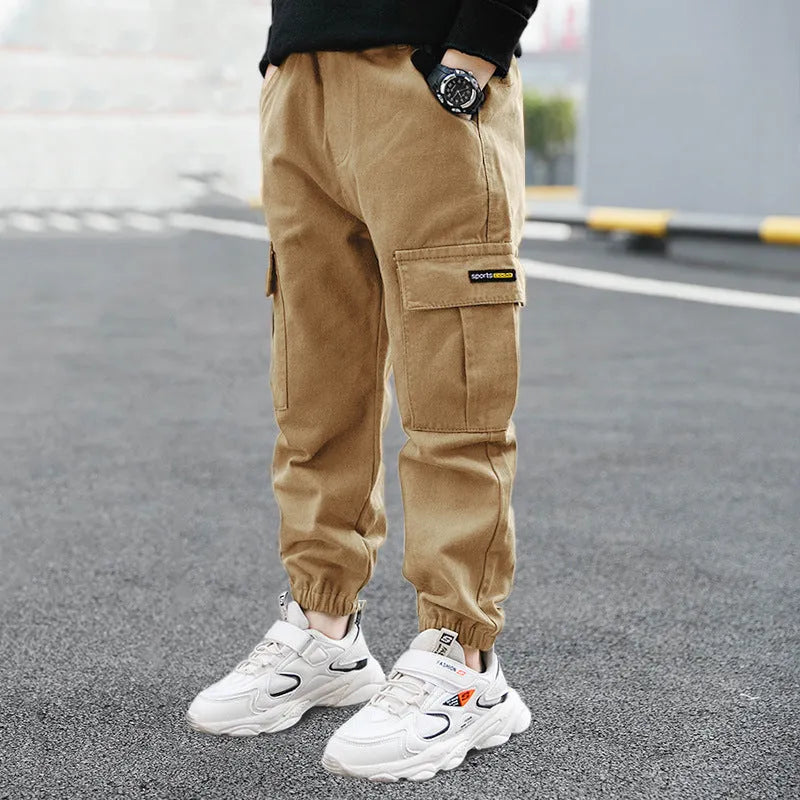 Boys' casual cotton summer trousers in khaki colour with elasticated waist, shown on size chart.