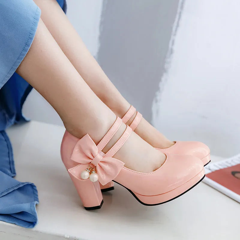 Red platform shoes with a thick chunky heel, round toe, and buckle fastening on a white background.