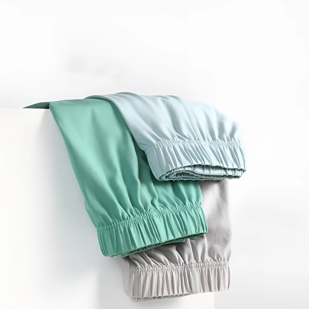 Men's loose-fitting cotton boxer shorts in gold, green, sea blue, and light grey colours showing mid-waist design