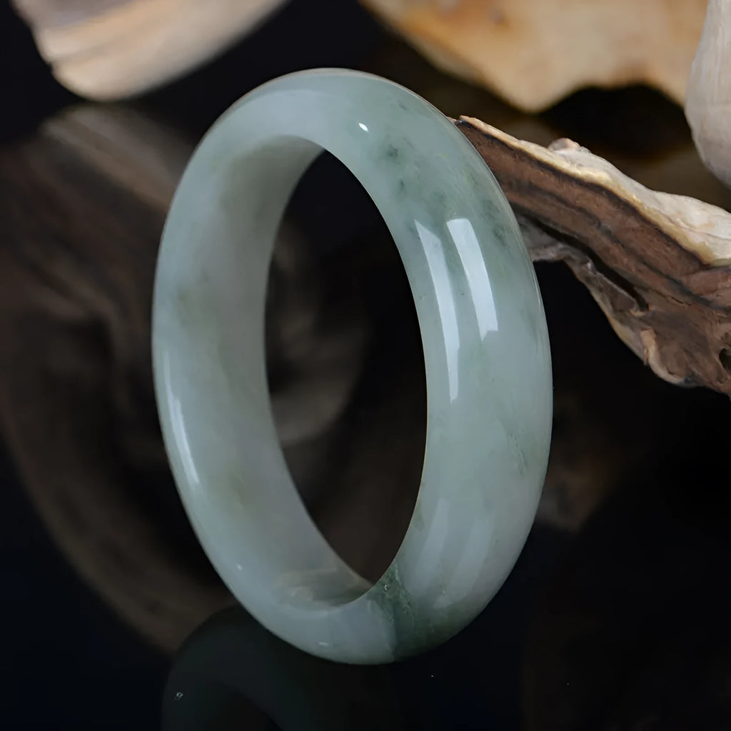 Natural Jinsi Jade Chinese style bangle bracelet on a plain background.