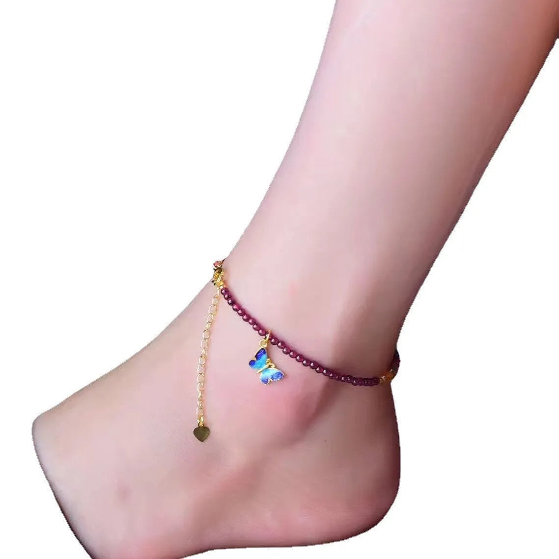 Purple garnet geometric anklet for women on an ankle.