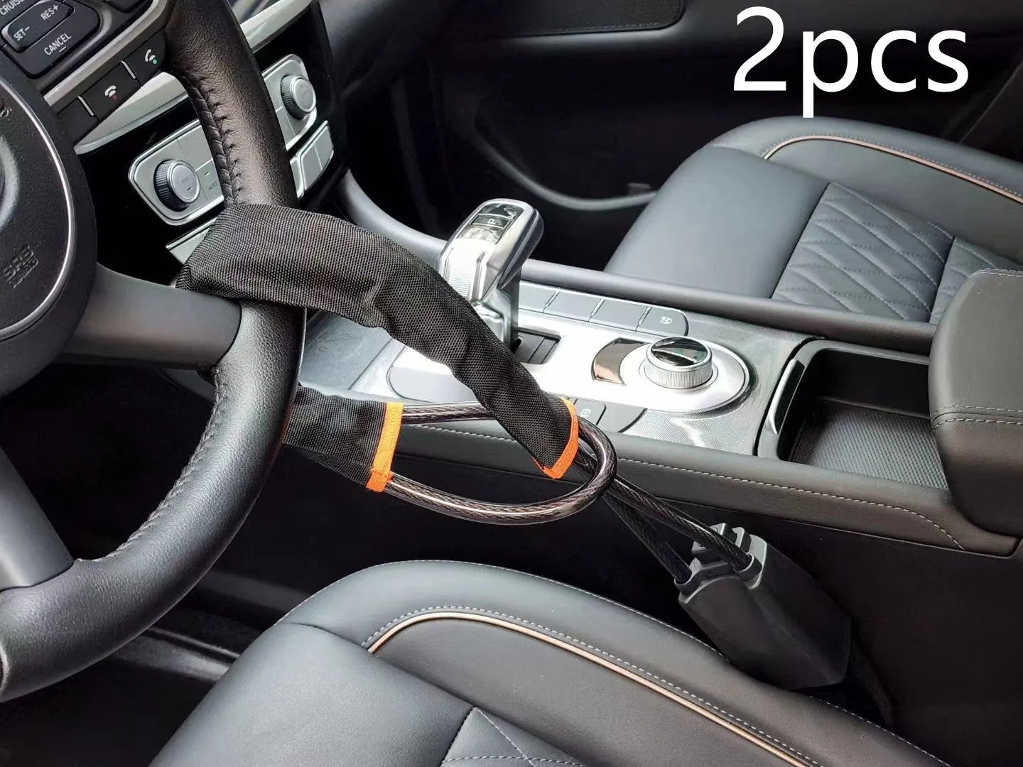 Red steel car steering wheel security lock with coiled cable on a car seat.