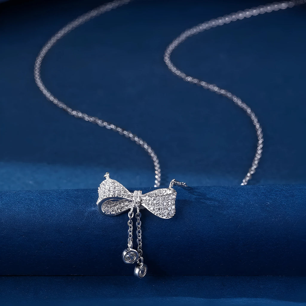 Sterling silver bow pendant necklace with O-ring chain on a 40-45cm adjustable chain.