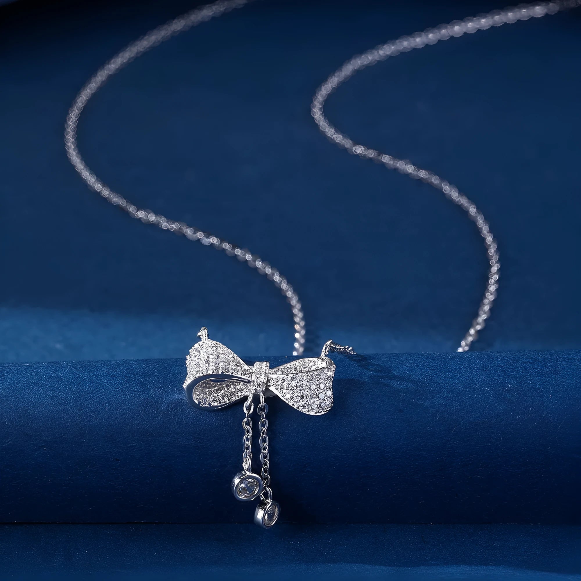 Sterling silver bow pendant necklace with O-ring chain on a 40-45cm adjustable chain.