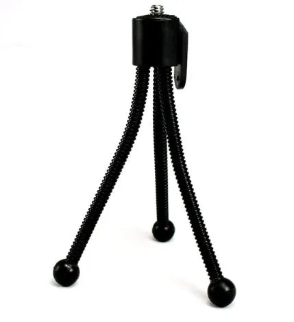 Small black iron frame mini tripod with ball head, shown extended next to a smartphone for scale.