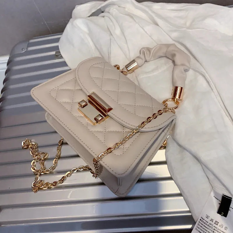Small square purple shoulder bag with chain messenger strap showing dimensions