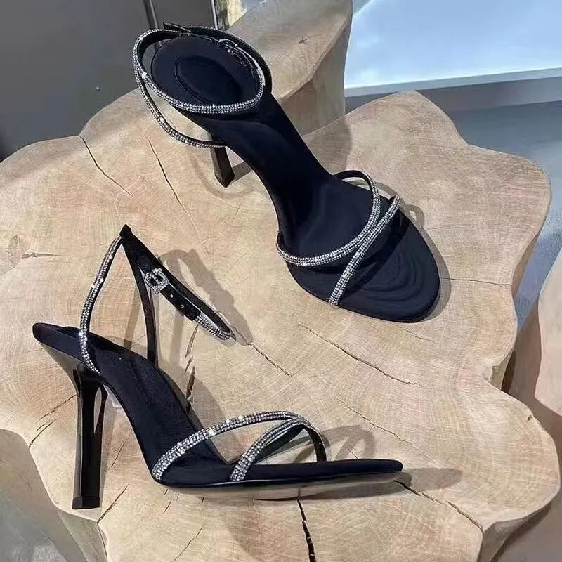 Women's rhinestone cross strap stiletto high heels in black with pointed toe and 9cm heel