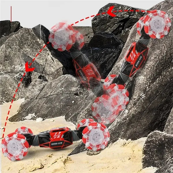 4WD RC stunt car with gesture remote control in red colour on white background showing off-road wheels and LED lights
