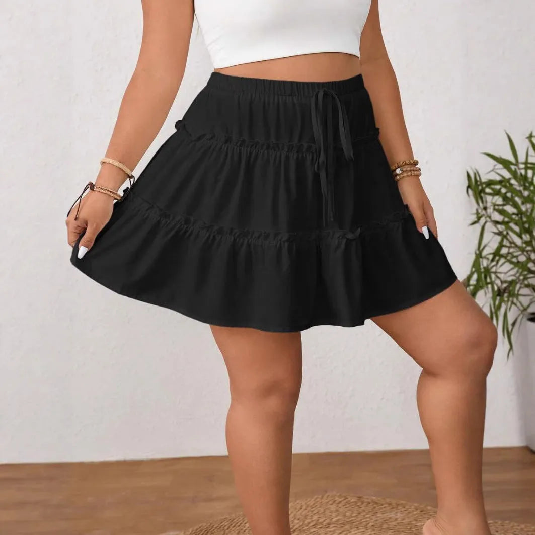 Women's white adjustable lace-up pleated A-line skirt on a model.