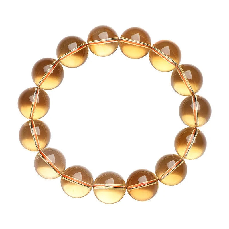 Natural yellow citrine scattered beads bracelet on a wrist, showing polished gemstones on a knotted cord.