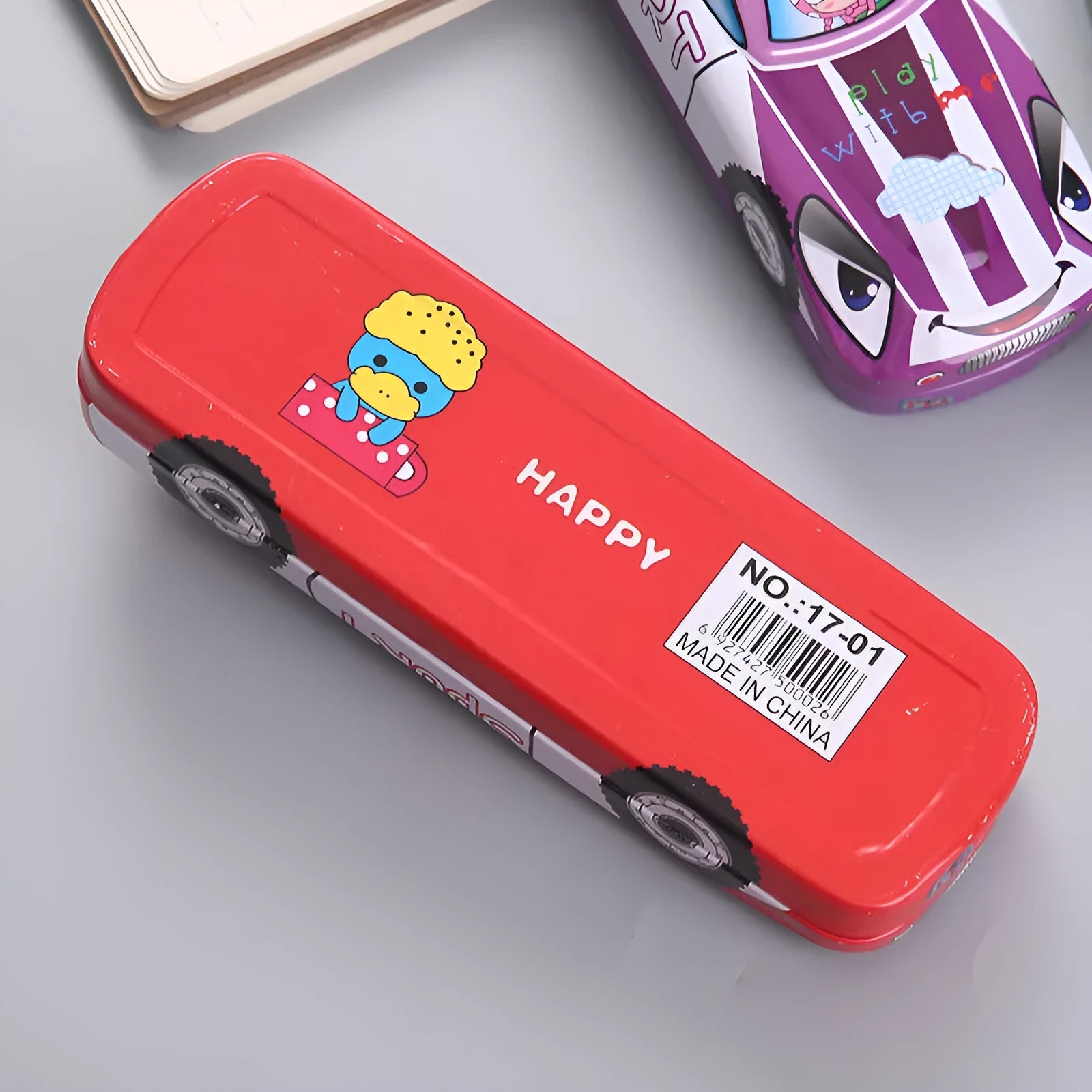 Red and blue cartoon race car design metal pencil case with double-layer trolley shape, shown with pens inside.