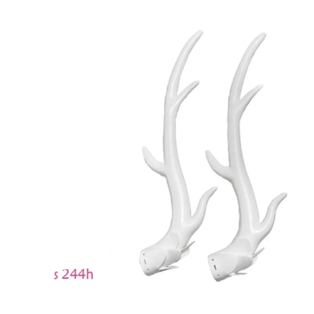 A pair of black resin dragon horn decorations for motorcycle helmet customisation, showing curved shape and mounting base.