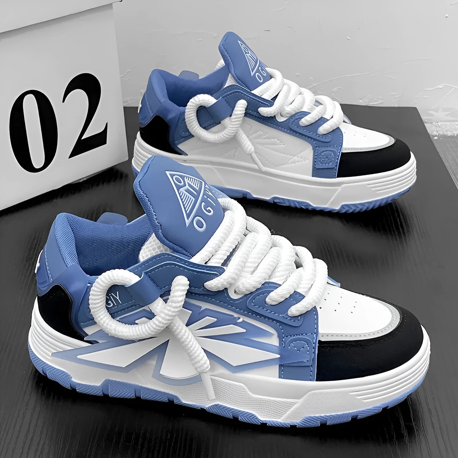 Men's white chunky sneakers with thick rubber sole and synthetic leather upper on a casual background.
