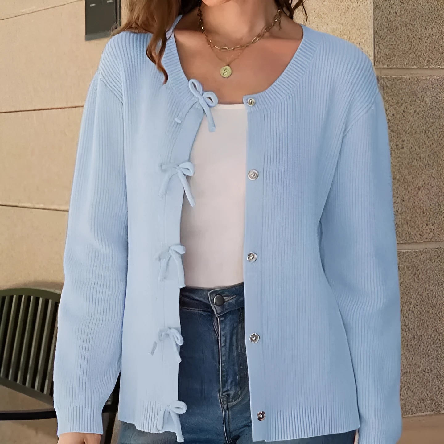 Women's long sleeve knitted cardigan with bow pattern in loose fit, available in multiple colours, shown on model
