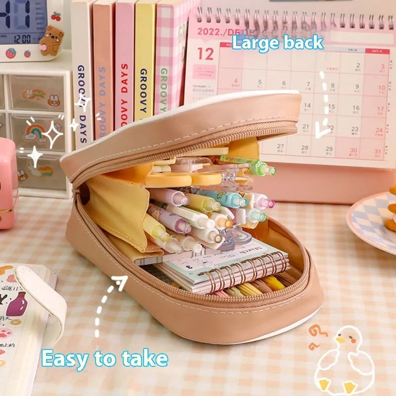 Transparent PVC student pencil case with Korean-style cartoon design showing stationery storage capacity