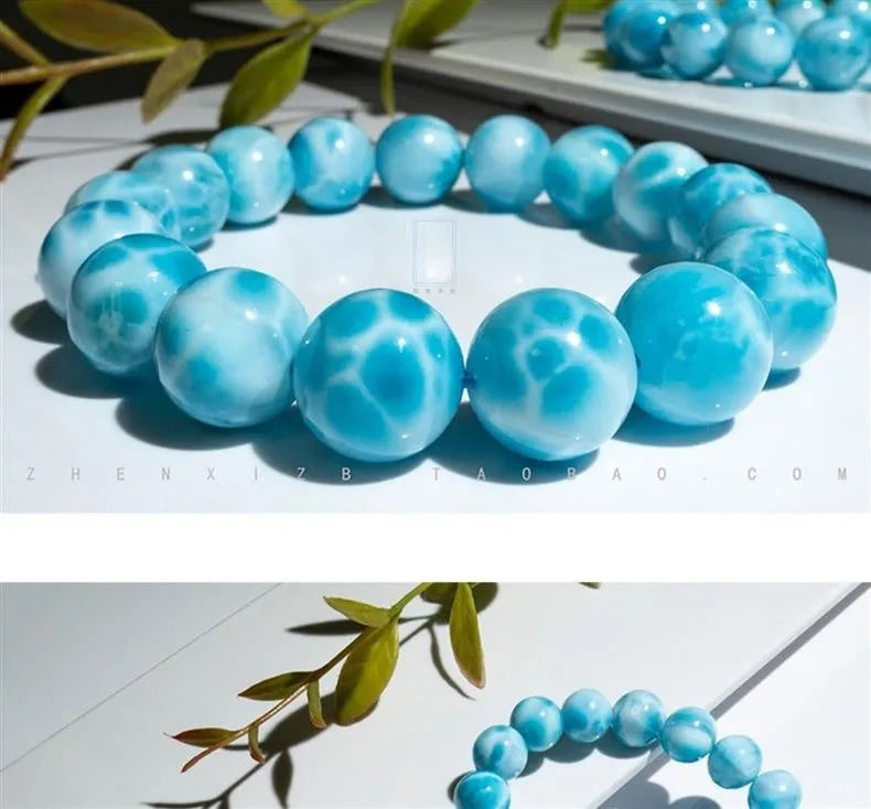 Blue natural crystal sea-pattern stone and Bodhi bracelet with pearl details on a white background.