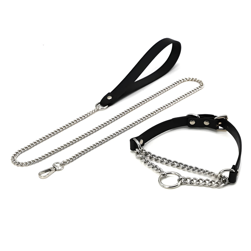 Black leather collar with chain detail and attached black leash on a dark background.