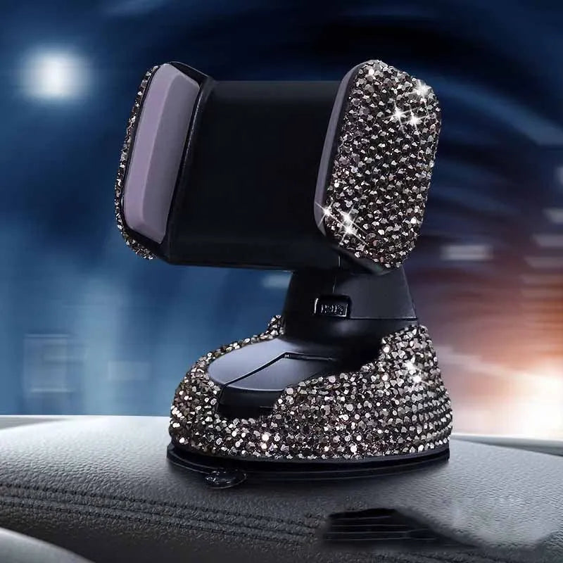Diamond-encrusted car phone holder mounted on air vent with adjustable push-button mechanism and smartphone securely held