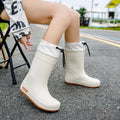 Women's solid colour rain boots with non-slip soles in apricot, black, brown, and pink waterproof finishes