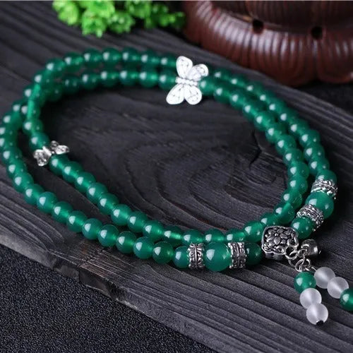 Green agate multi-layer women's bracelet with three circles of 6mm beads on an adjustable chain.