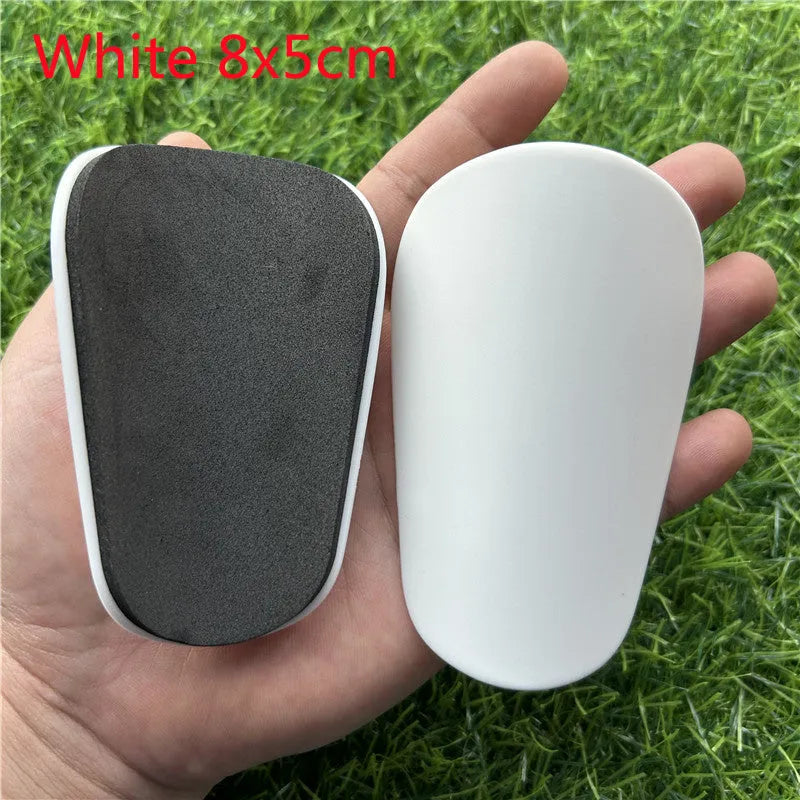 Extra small mini football shin guards in black and white plastic for youth players