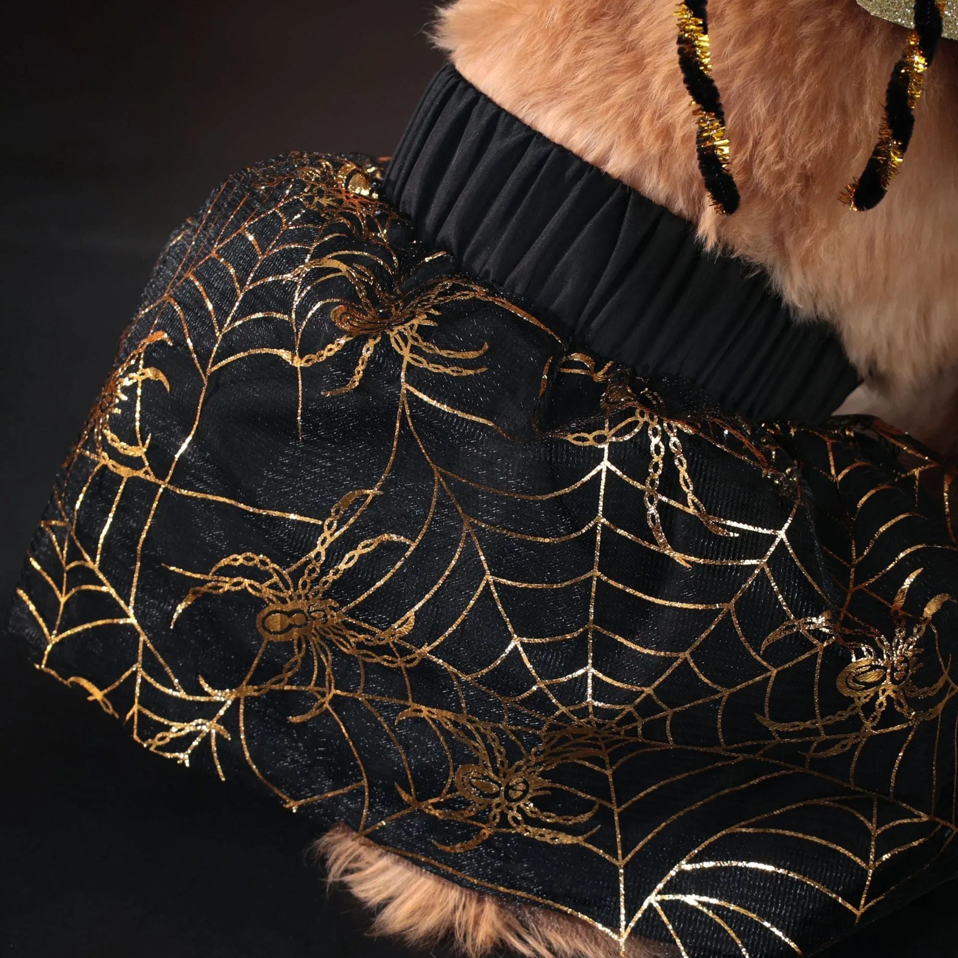 A dog wearing a smart suit-style Halloween costume in a classic suit colour.