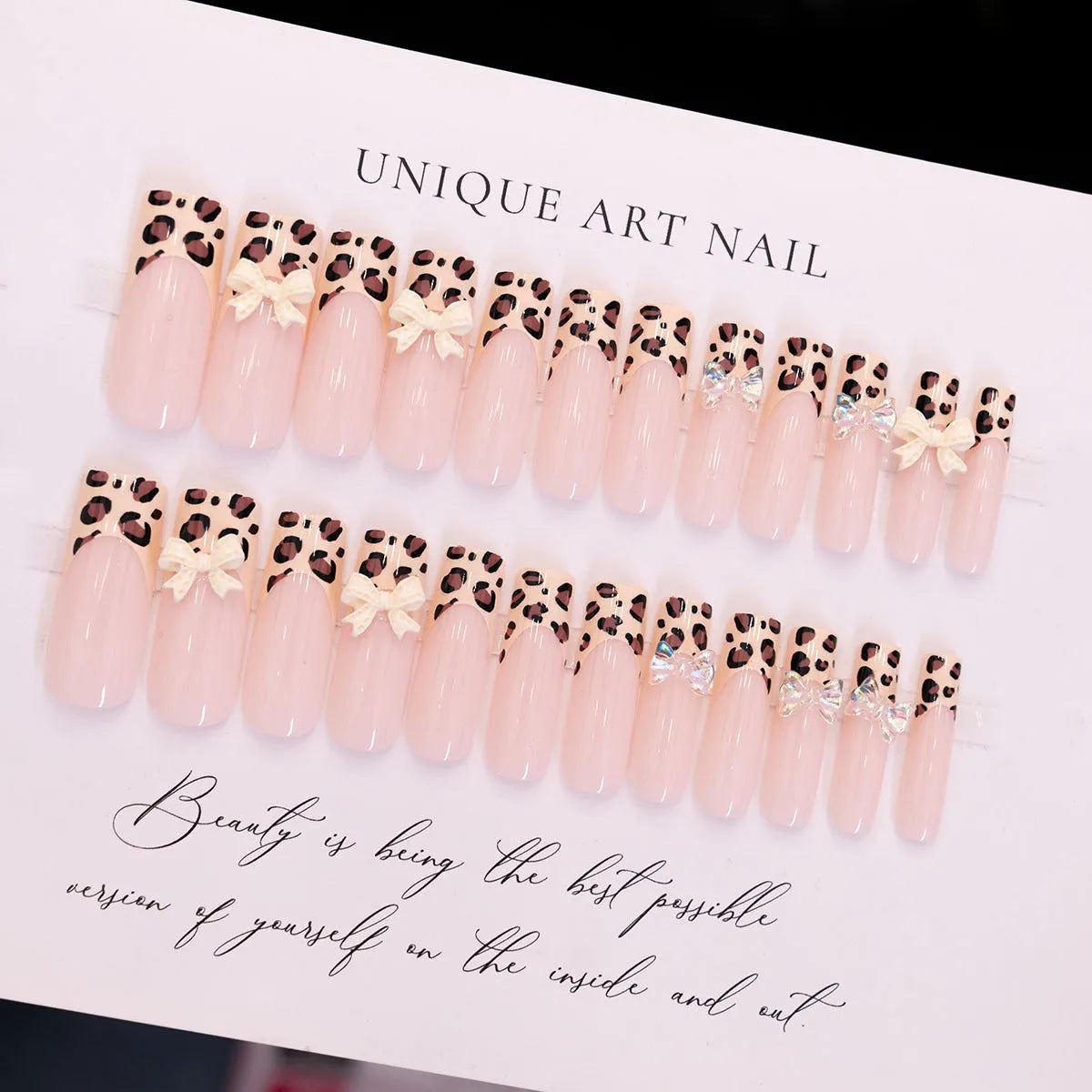 Set of plastic leopard print butterfly nail art decoration pieces on a background.