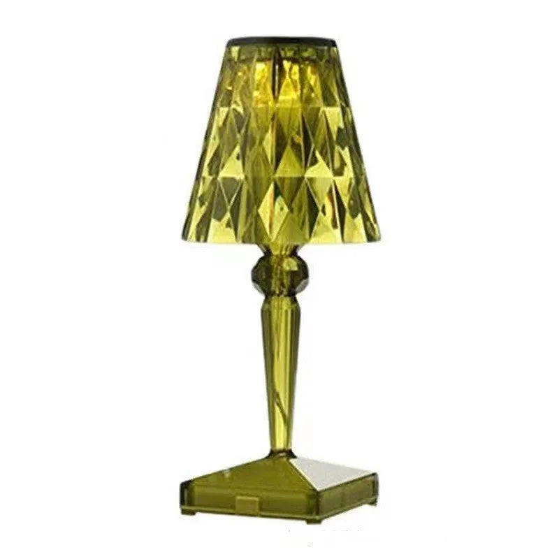 Rose gold plated portable touch night light with acrylic body on a surface.