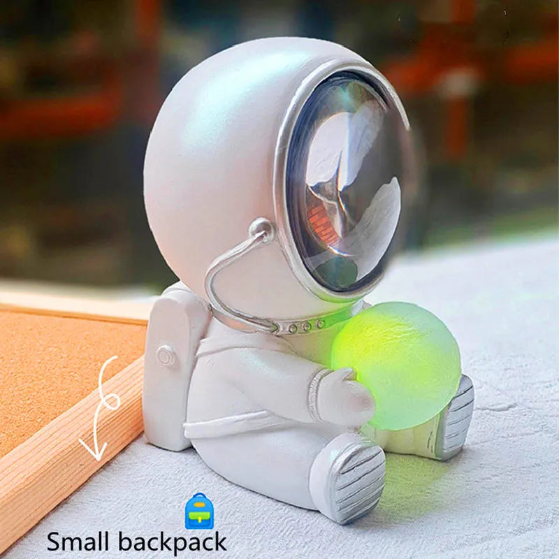 Resin bear-shaped starry sky night light with soft LED glow on a wooden table.