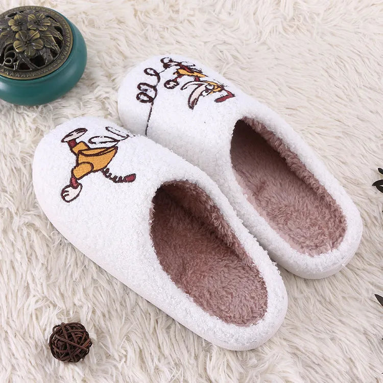 White cartoon pattern fluffy slippers with a non-slip rubber sole and toe holder design.