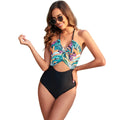 Women's black one-piece swimsuit with a printed red and green leaf pattern
