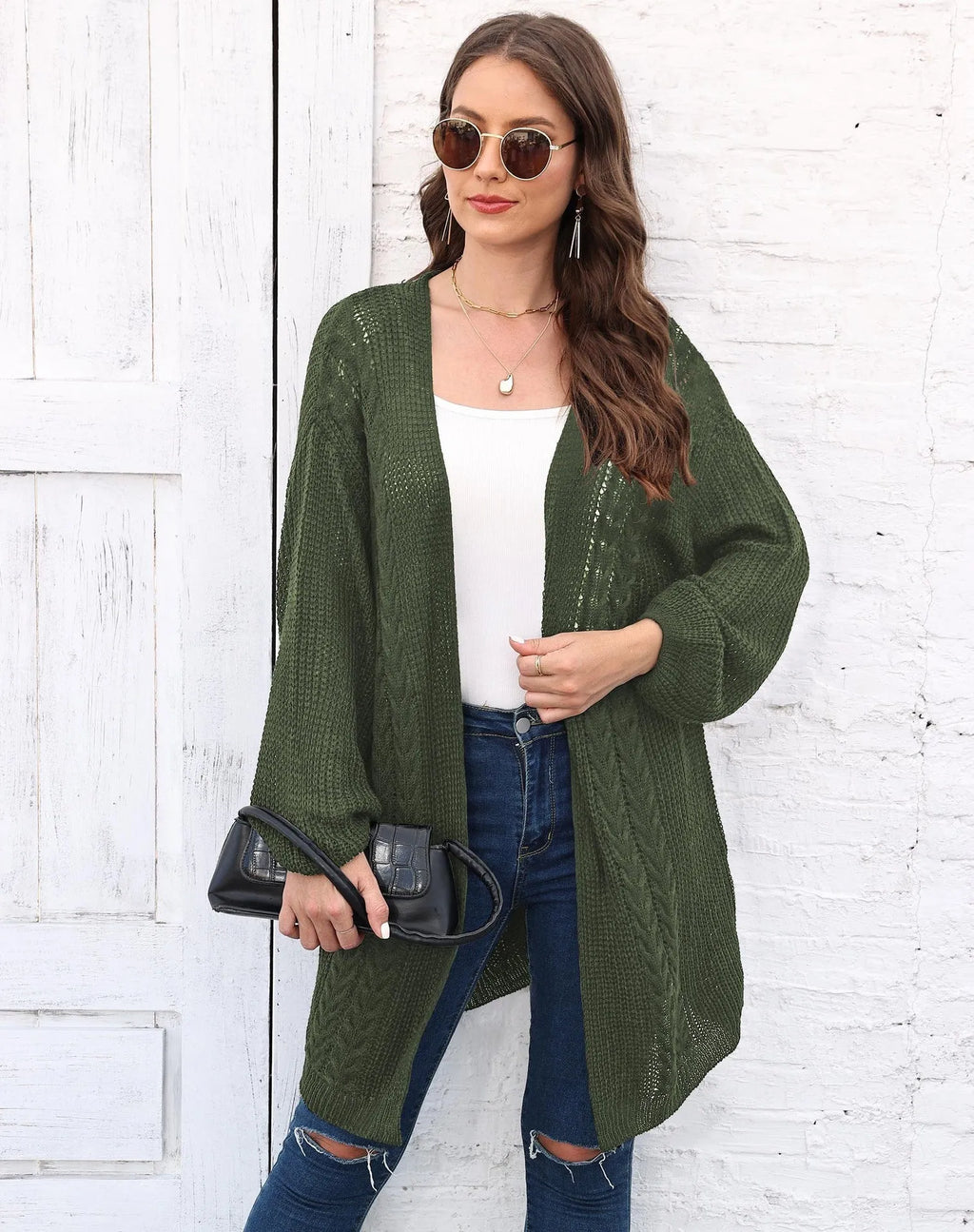 Women's longline loose acrylic sweater coat in army green colour, shown on a model.