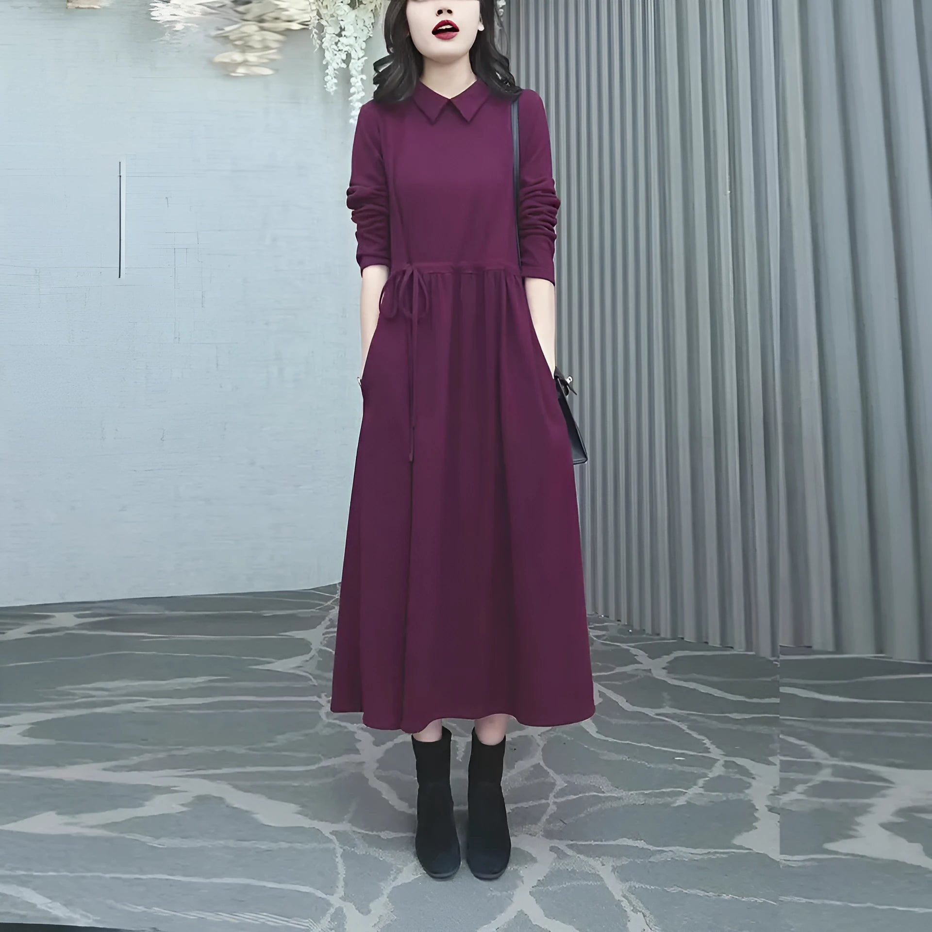 Purplish red women's long sleeve knee-length dress on a hanger, urban commute style.