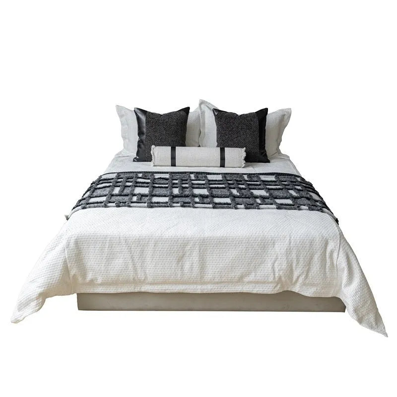 Grey and white plaid bed runner and nap blanket set with a pillow on a 1.8m bed, demonstrating universal fit.