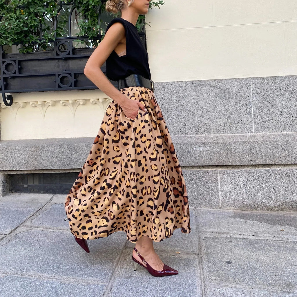Brown leopard print women's long A-line skirt with a deep hem, shown on a hanger.