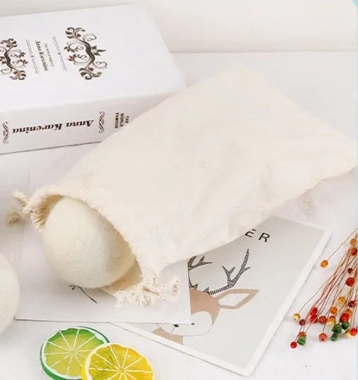 Wool laundry drying ball in various sizes with cotton storage bag for tumble dryer use