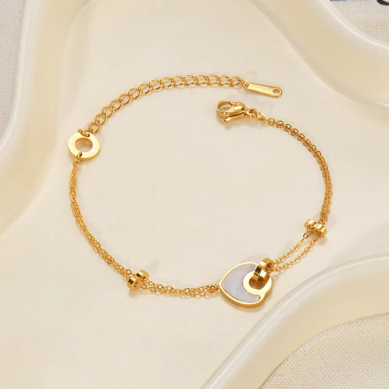 Silver stainless steel bracelet for women with a double-layer red resin heart charm.