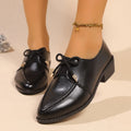 Women's simple leather-look shoes with a decorative bow, on a rubber sole.