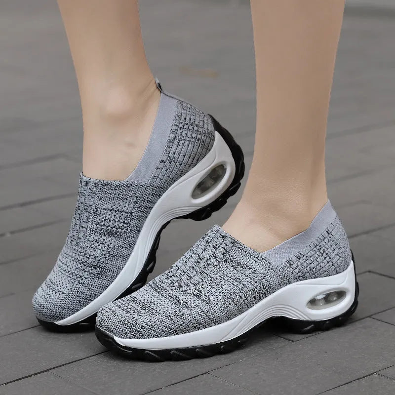Women's mesh slip on air cushion sneakers in black, with low top and thick bottom, side view
