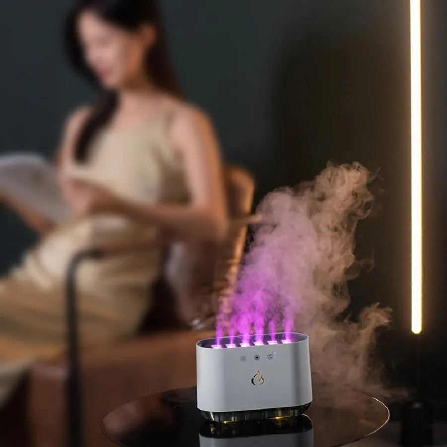 White large-capacity household humidifier with LED colourful lights and aromatherapy function on a table.
